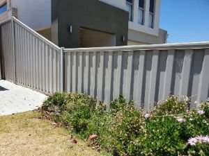 Light gray Colorbond fencing installed in a two-storey residential home in Melville WA for added security.