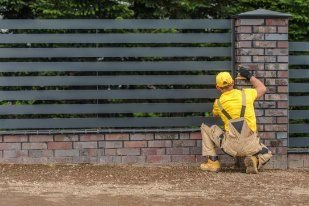 Professional fencing contractor in Melville WA working on a damaged metal fencing of a residential property.