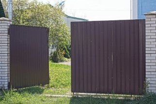Colorbond gates in brown colour installed in a residential property by the expert fencers in Melville WA.